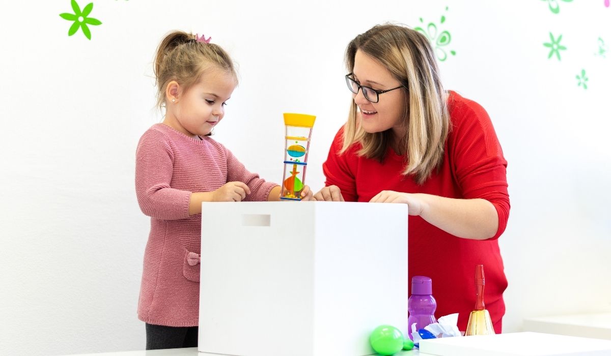 parent supporting child during autism therapy
